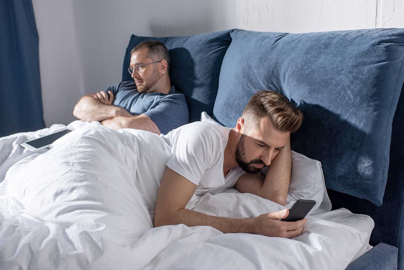 Men in Bed Texting