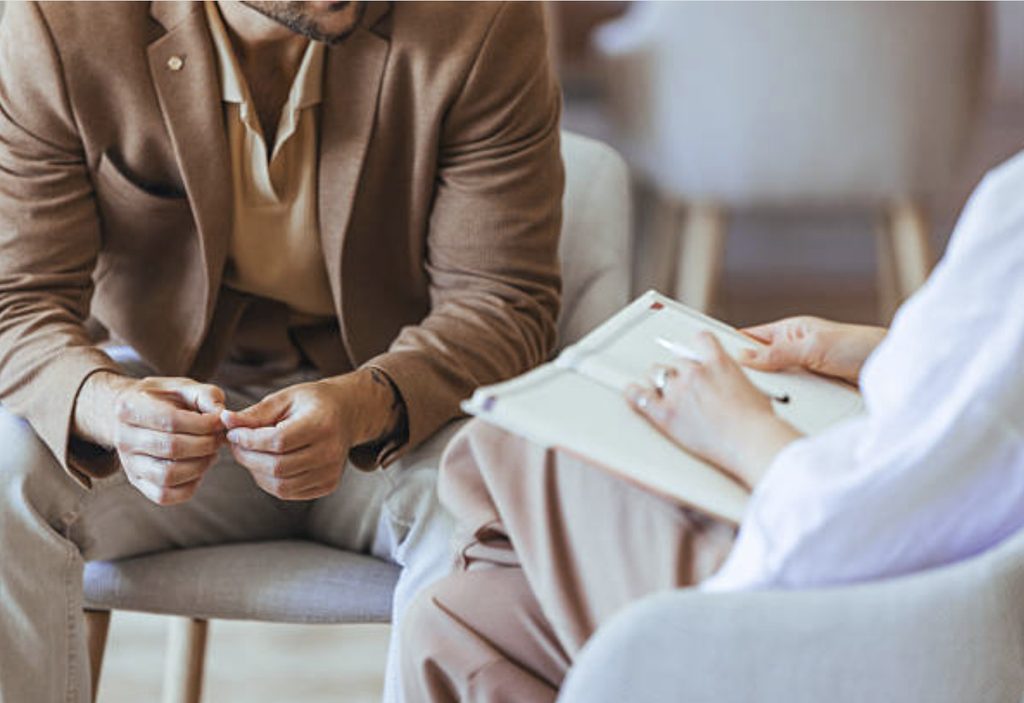 LGBTQIA+ affirming therapist in Denver listening to a client during a session